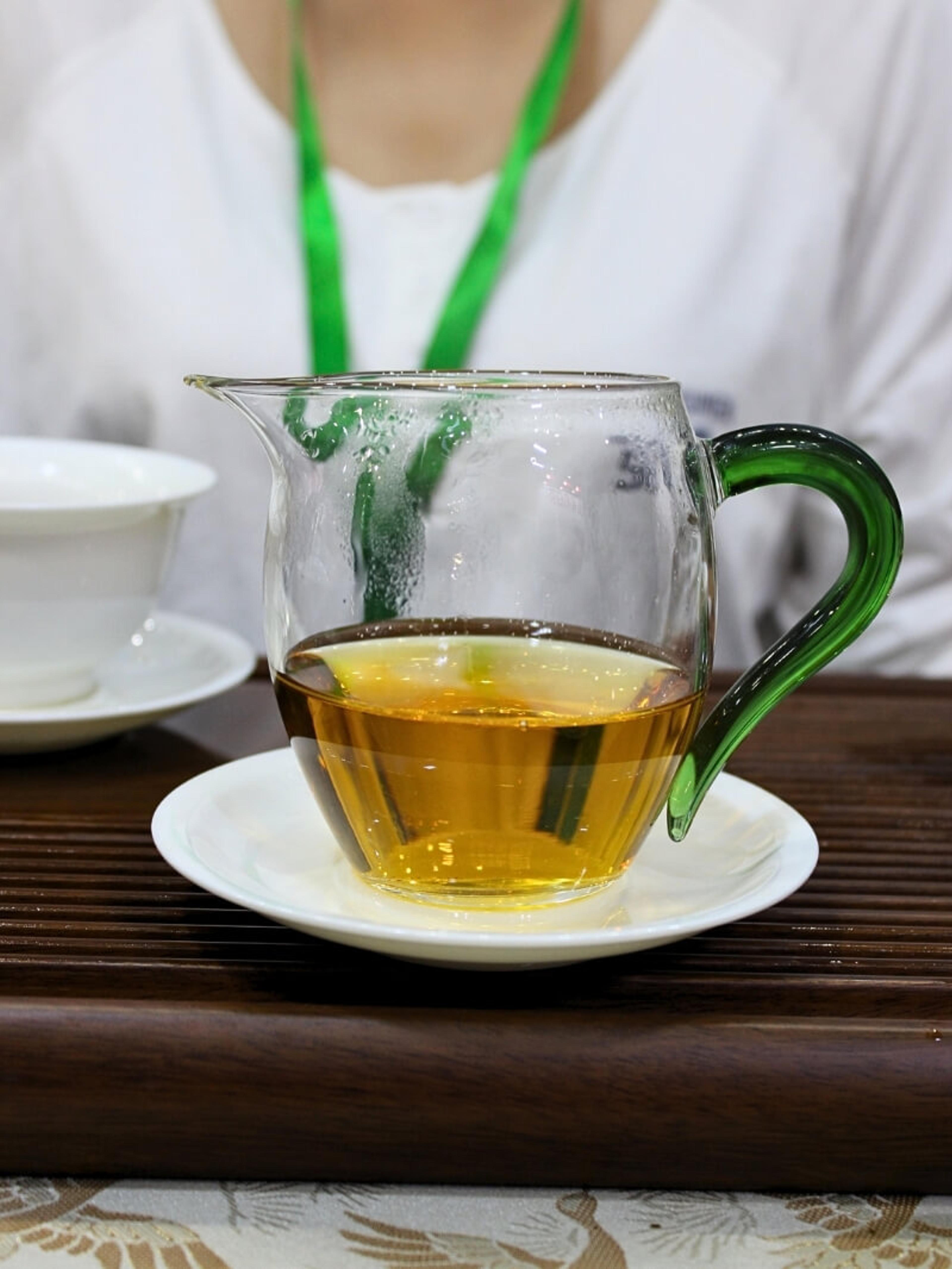 Sun-dried red tea liquor in a glass pitcher.