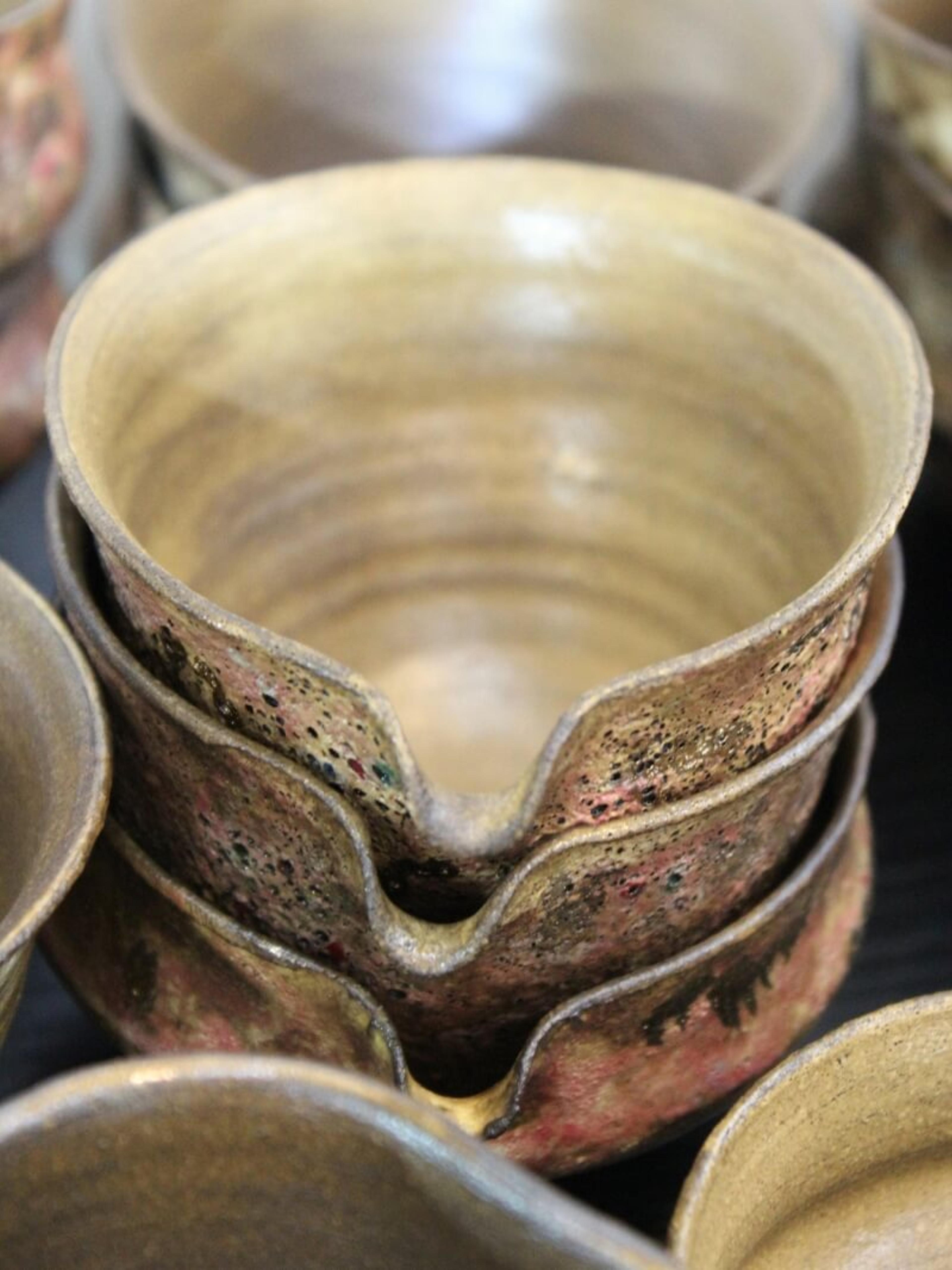 Stacked rustic clay bowls.