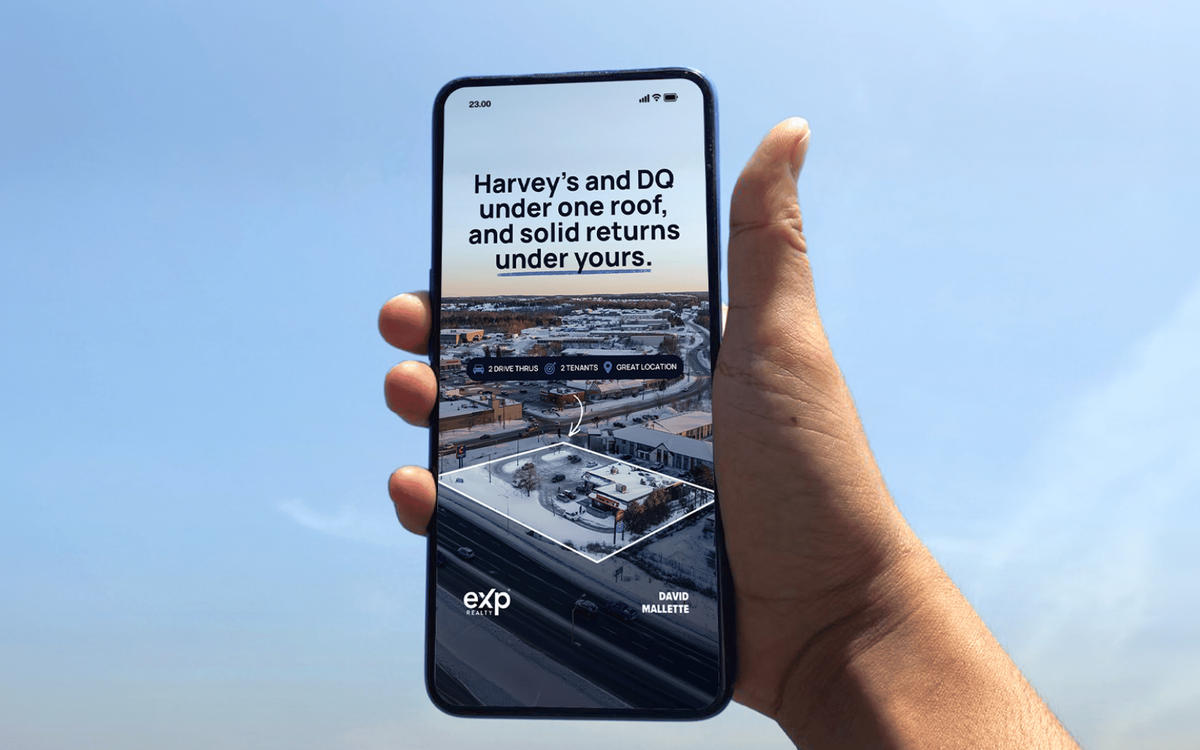 Hand holding a phone displaying a commercial investment property ad for a plaza with Harvey's and DQ, listed by eXp Realty.