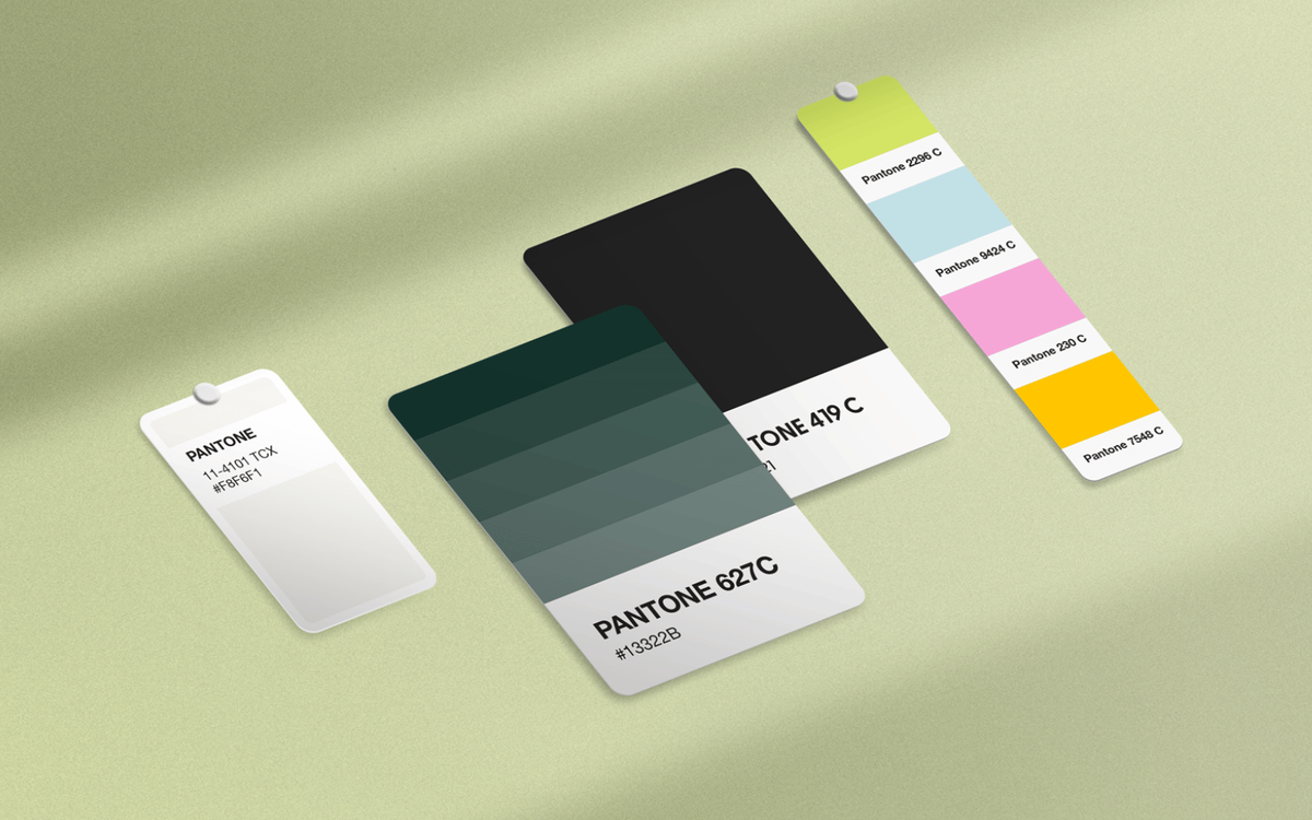 Pantone color swatch cards showing a green gradient palette, black, and a bright secondary palette of green, blue, pink, and orange.