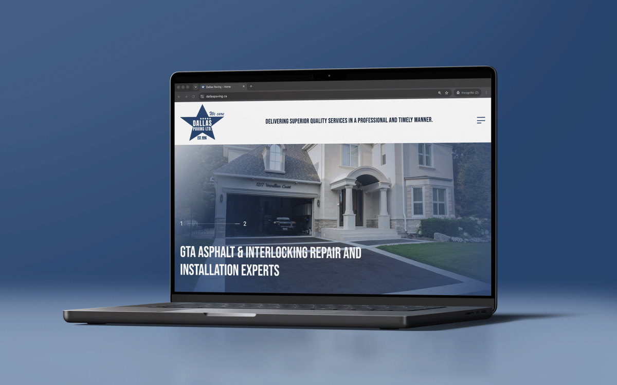 Laptop displaying a paving company website homepage with a driveway photo and headline about asphalt and interlocking services.