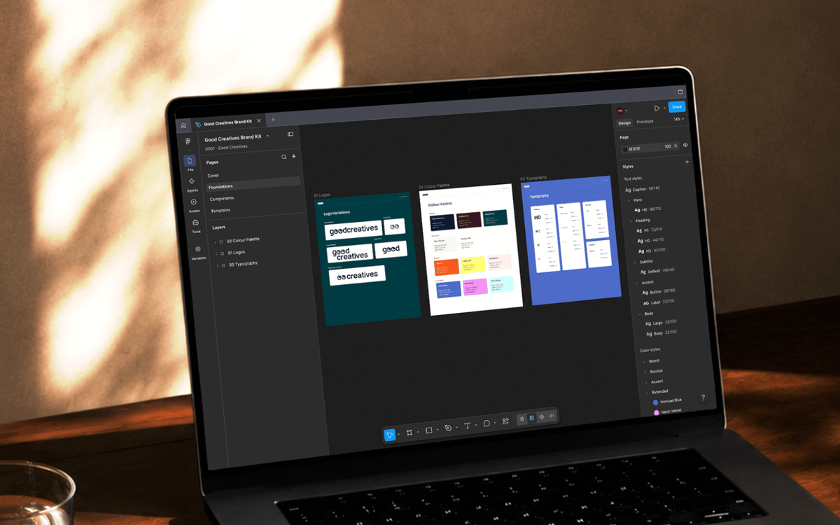 A laptop showing the Good Creatives brand kit in Figma, including logo variations, a color palette, and a typography scale.