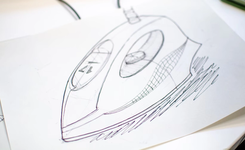 a final, well-sketched clothes iron in pen on A4. some details including controls on the handle of the iron