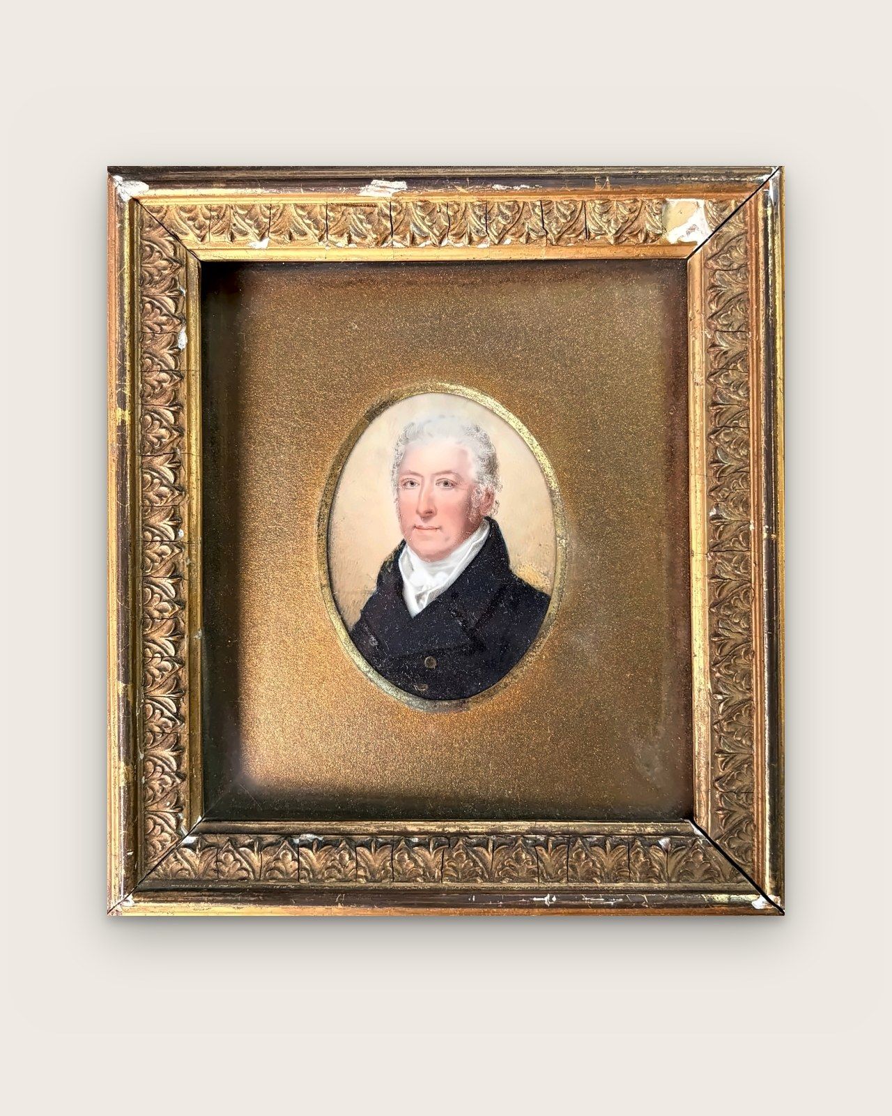 Oval miniature: portrait of a white-haired man in a dark coat, in a gilded frame