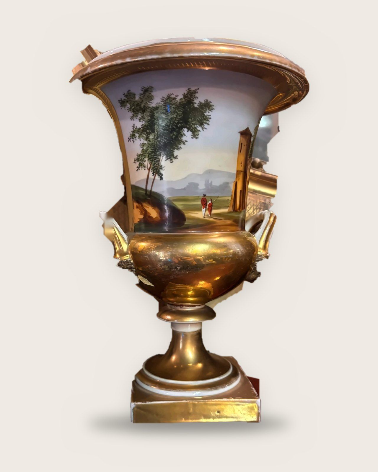 Gilded crater vase painted with a landscape of trees and a tower