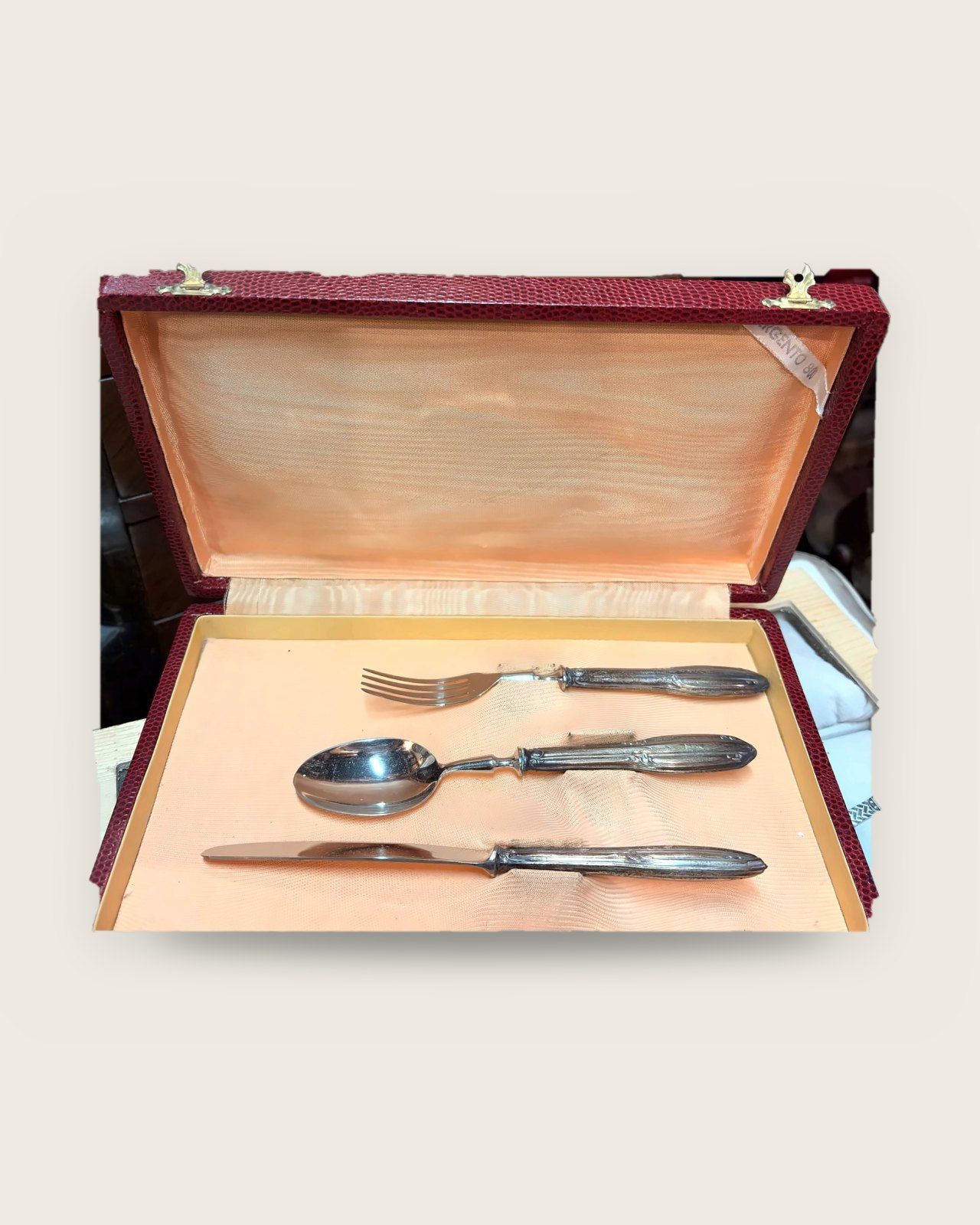 Fork, spoon and knife in a red case lined in peach