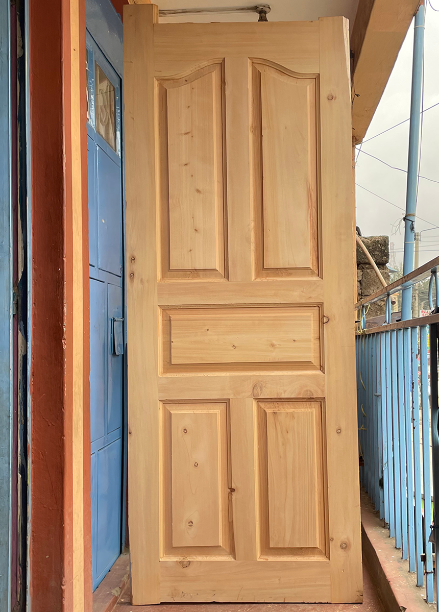 Cypress 5 panel solid wooden door with natural timber finish installed in a residential property in Kenya - 1 of 2