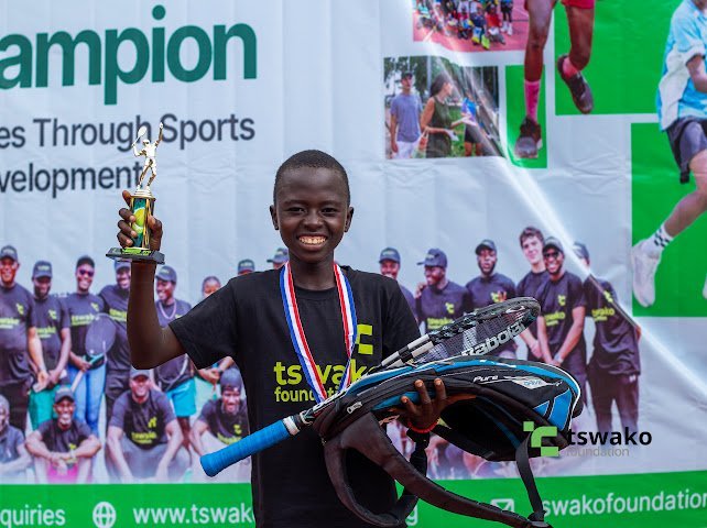 Player celebrating with her medal at the 9th edition tournament