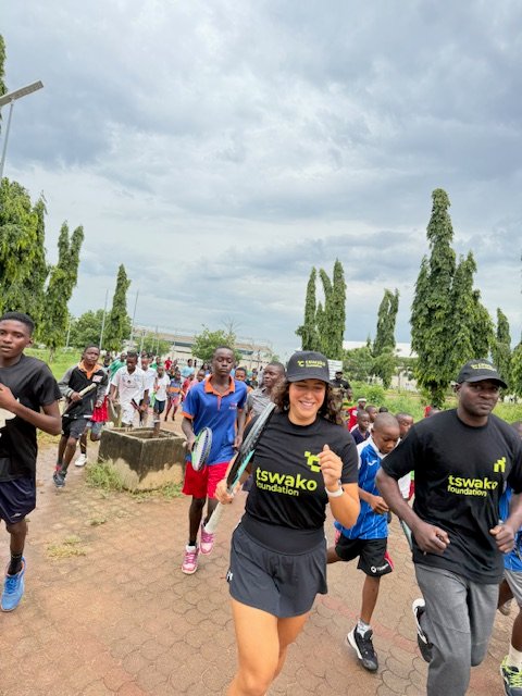 Volunteer coaches and young players on a run together at the National Stadium