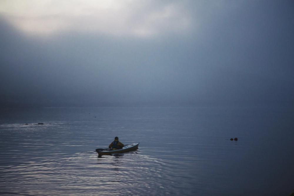 Kayaker on the sea in mist