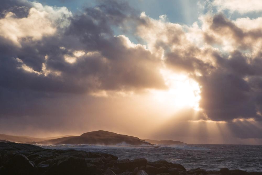Sun shining through the clouds over the coast of Burra