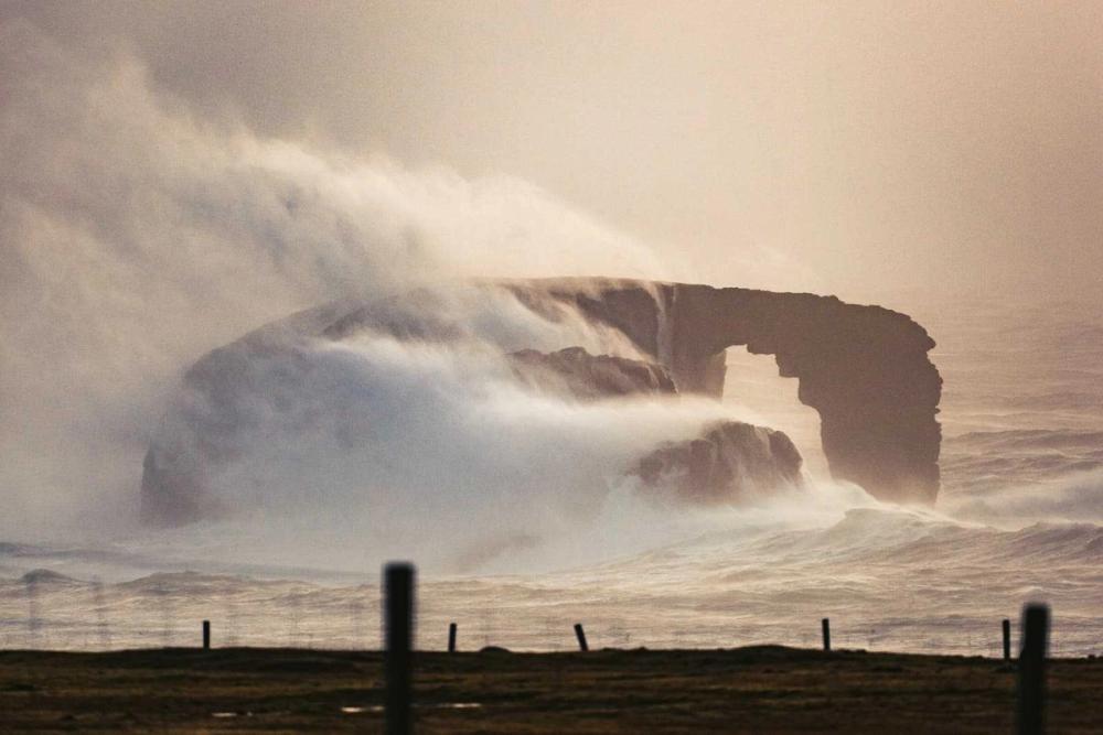 Large waves crash over Dore Holm, Shetland