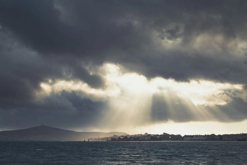 Sun shining through the clouds above the town of Lerwick