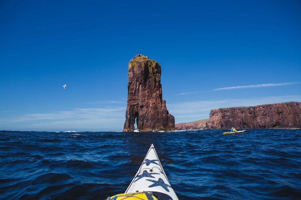 Kayakers near a sea stack