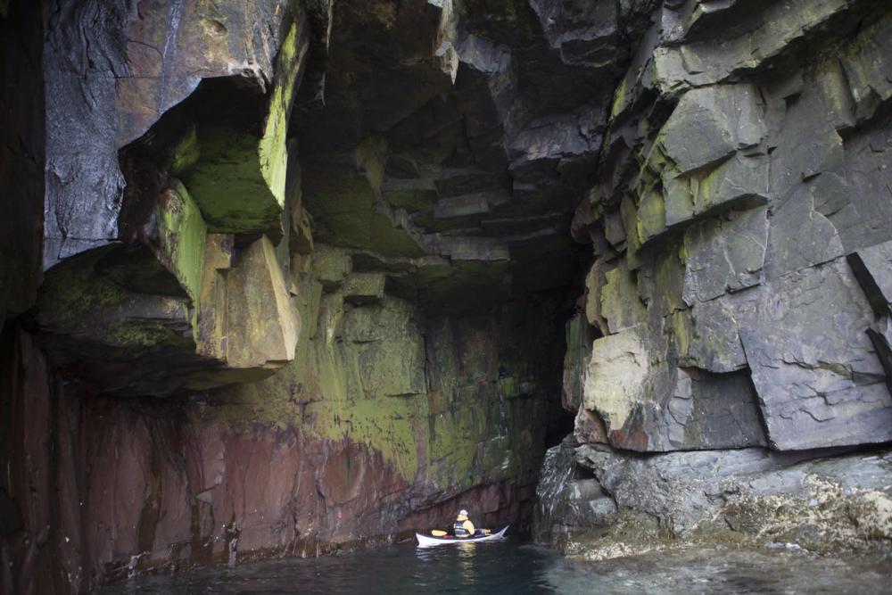 Kayaker going into a cave