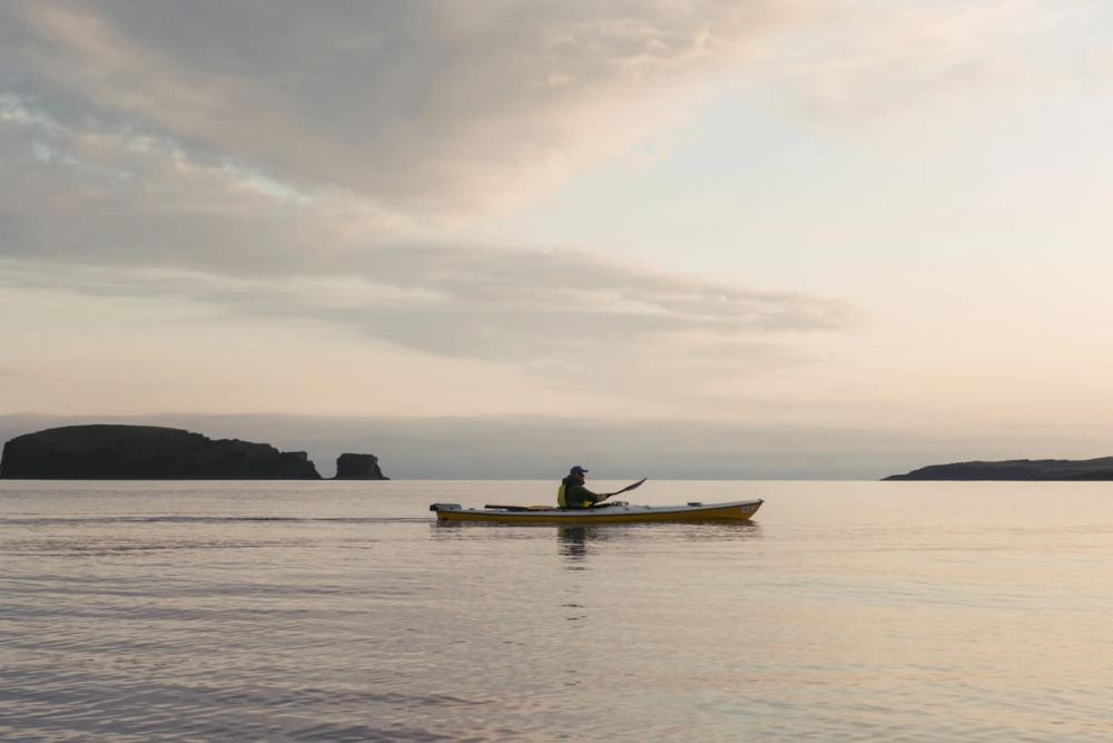 Kayaker at sea in the evening