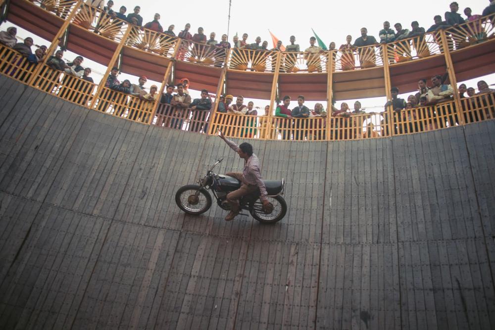 A motorcyclist goes round the well of death