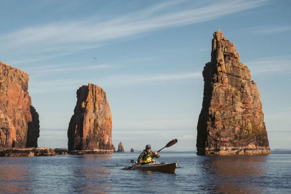 Kayaker infront of sea stacks