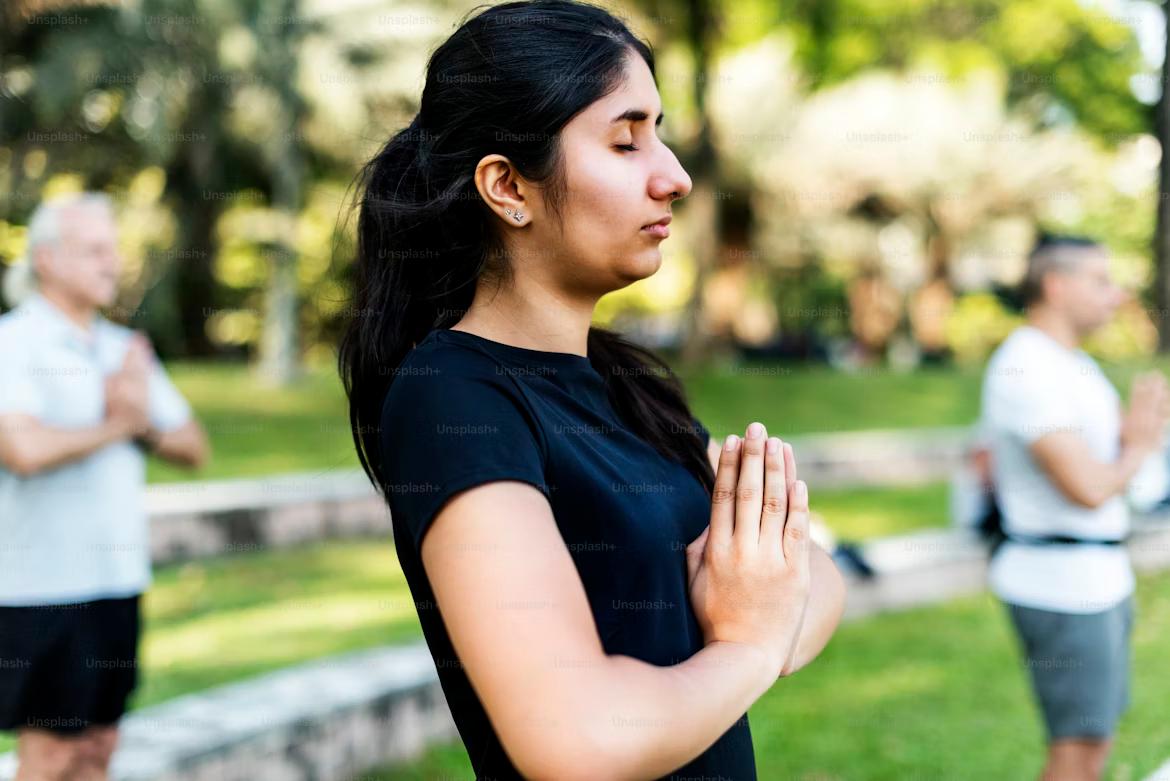 Person in a comfortable seated position in a quiet, softly lit meditation space