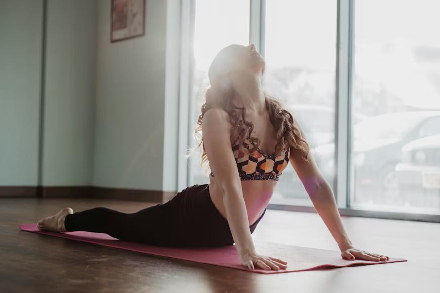 Person moving through a flow yoga sequence in a calm, bright studio space