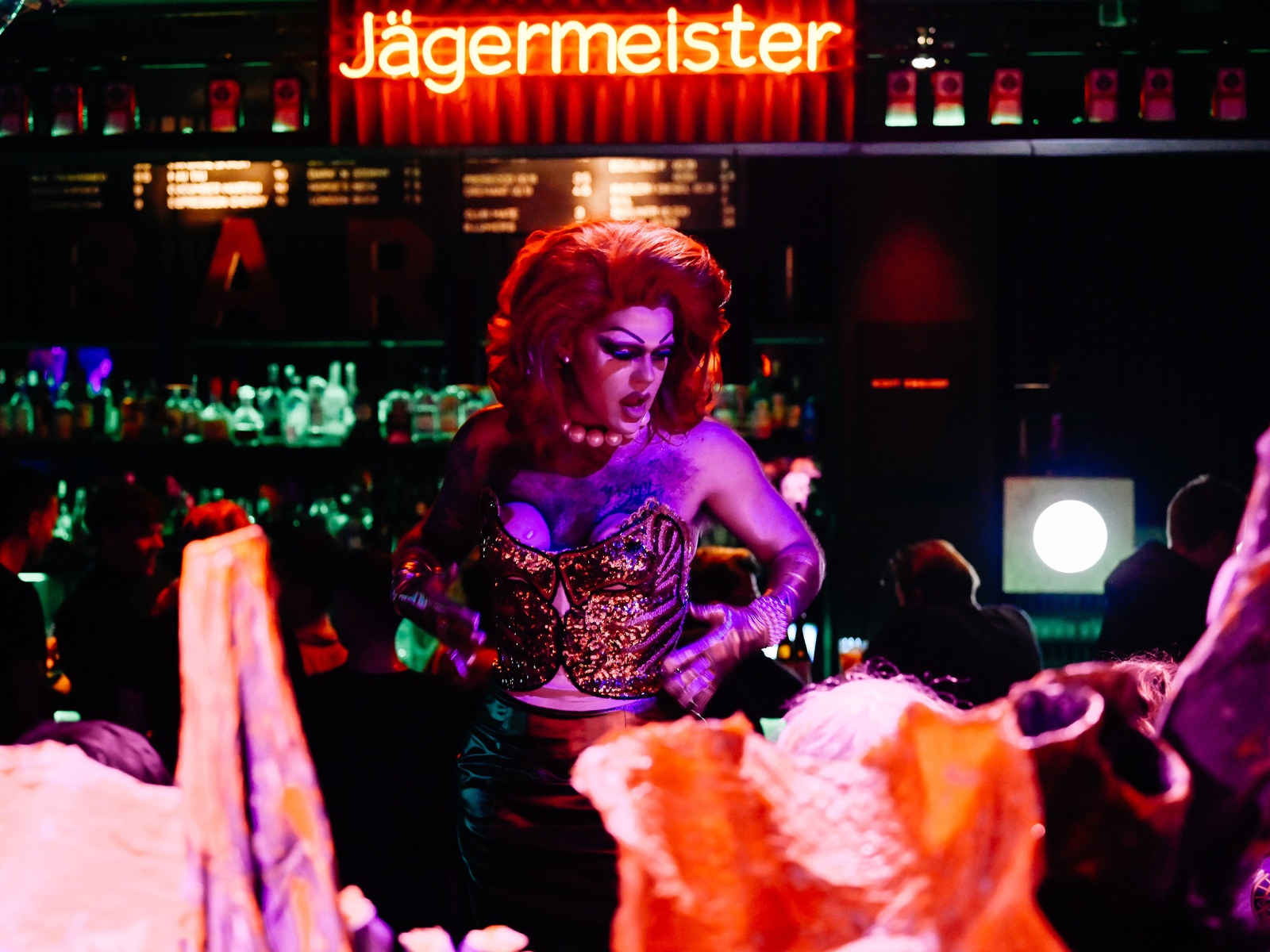 A picture of Pansy posing in front of a Jägermeister bar. Photograph by Camille Blake