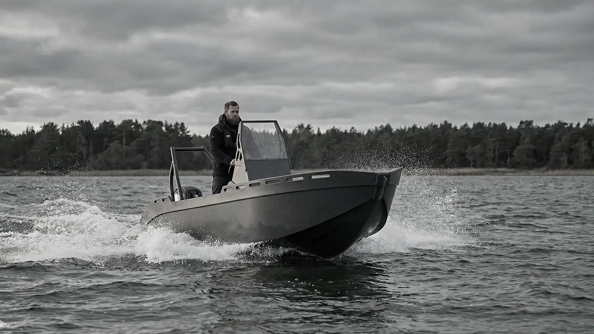 Ormrin HDPE workboat underway off a forested Baltic shoreline