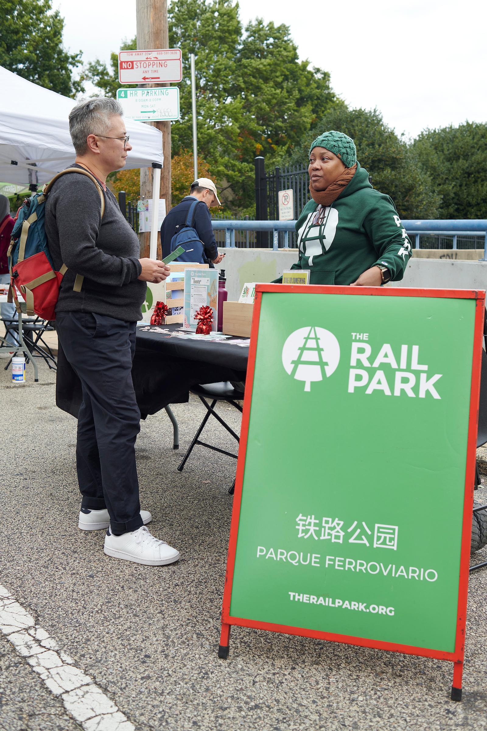 Photo courtesy of Albert Yee. People speaking at the Rail Park table.