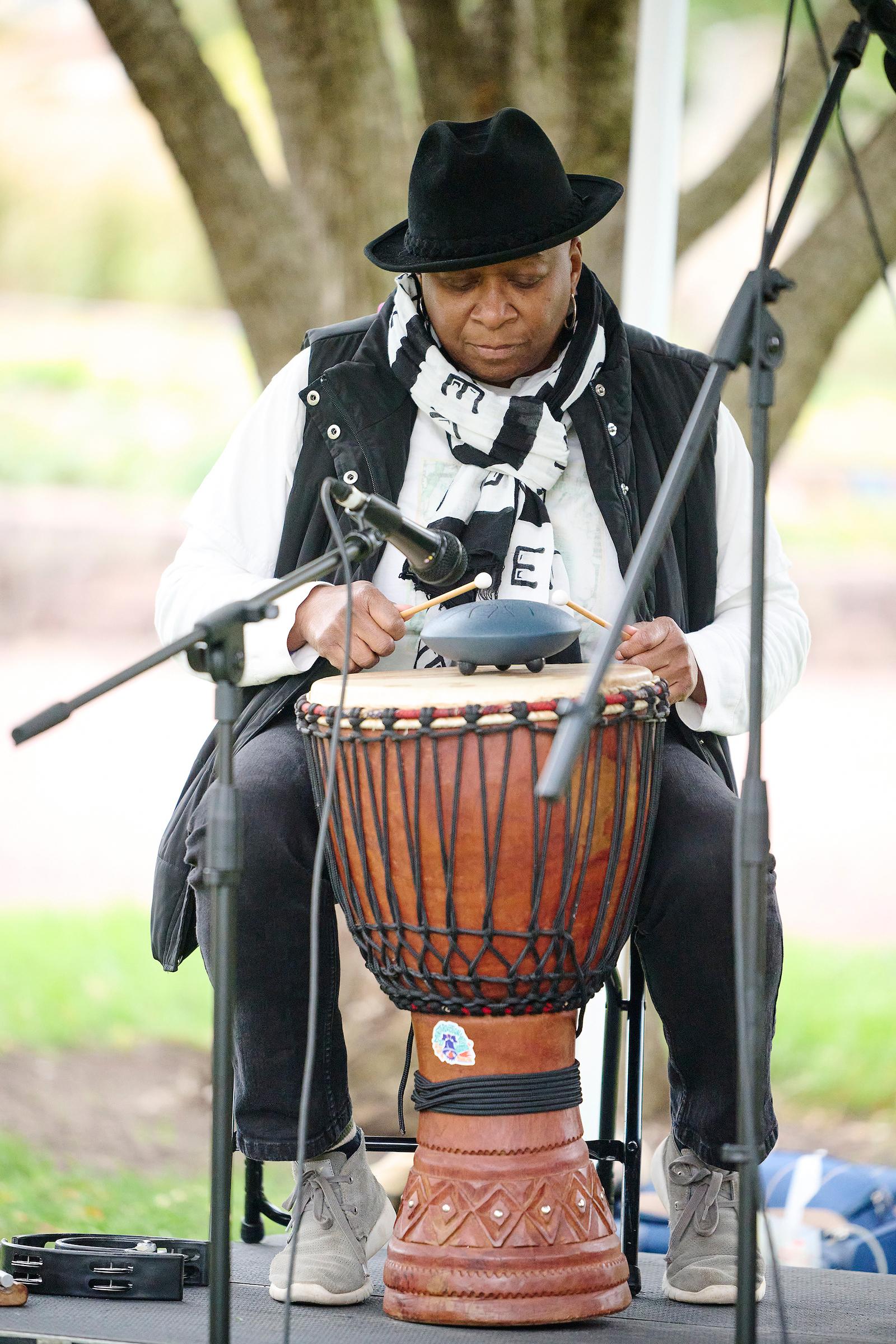 Photo courtesy of Albert Yee. Music performance at AAI Block Party showing person playing drums on stage.
