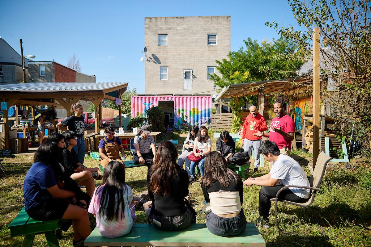 Photo courtesy of Albert Yee. Students and teachers sitting and listen to instructor at Inglesias Garden.