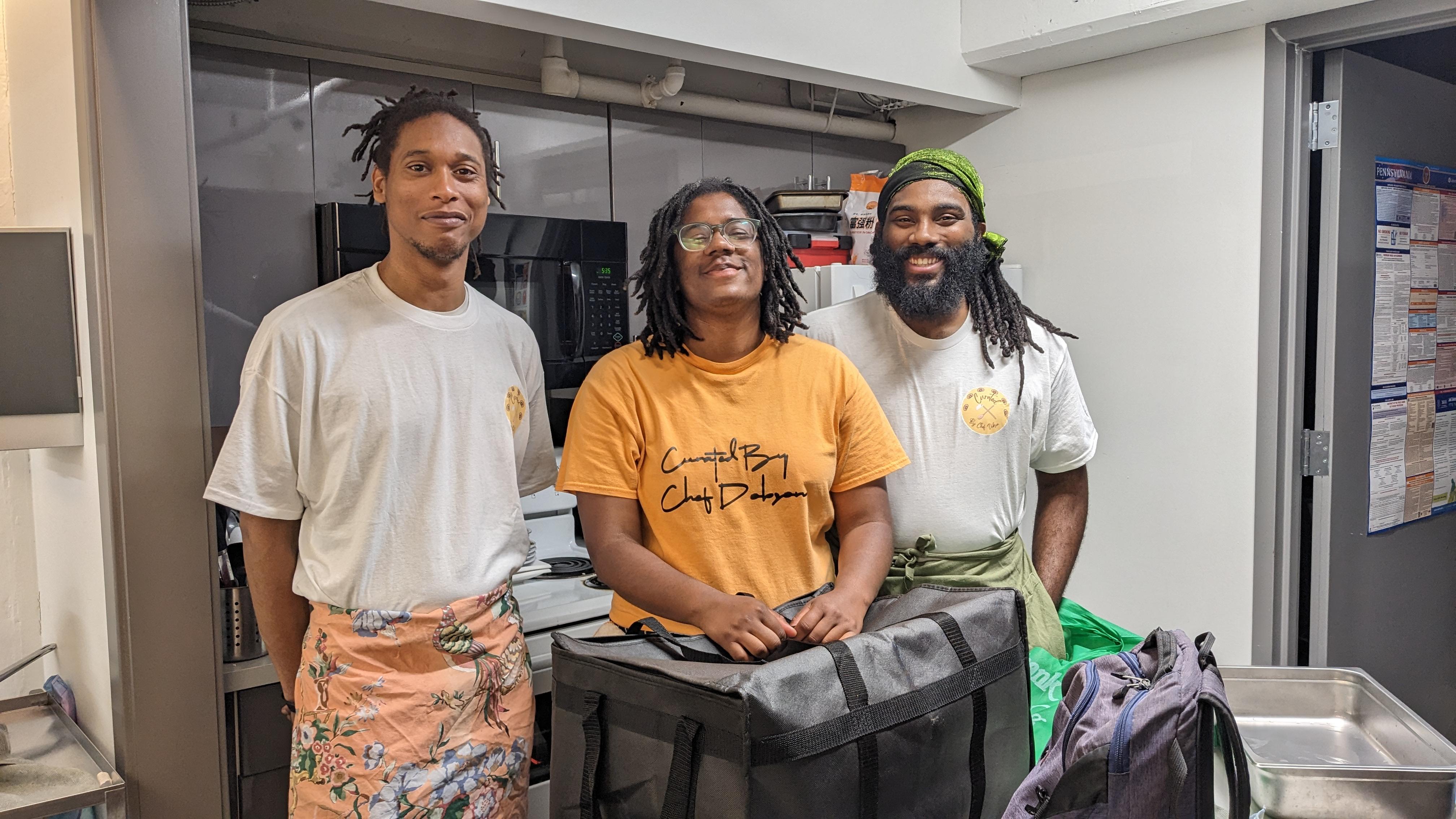 Photo by eo Studio. Chefs standing in the kitchen at the Invasive Species dinner.