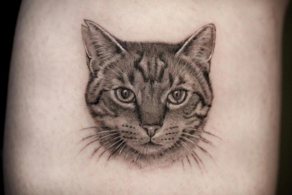 Microrealism tattoo: portrait of a tabby cat with fine whiskers
