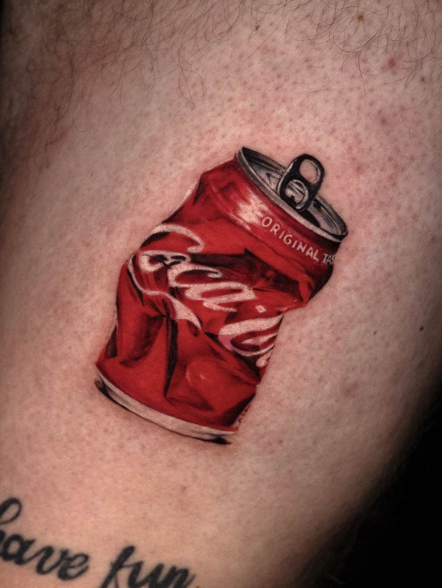 Tiny colour microrealism tattoo of a soda can