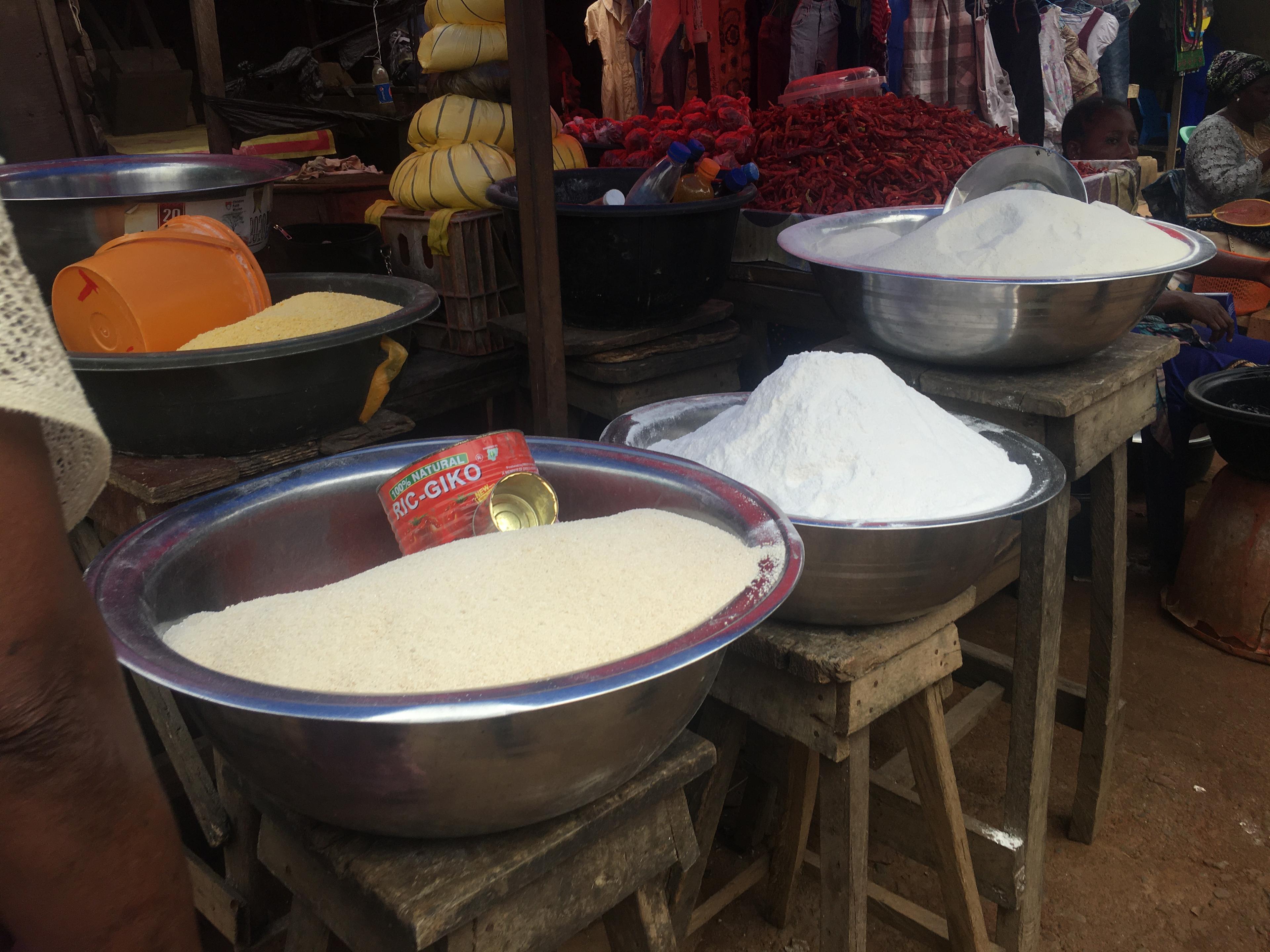 Bowls of grain and milled cereals on display at a local market.