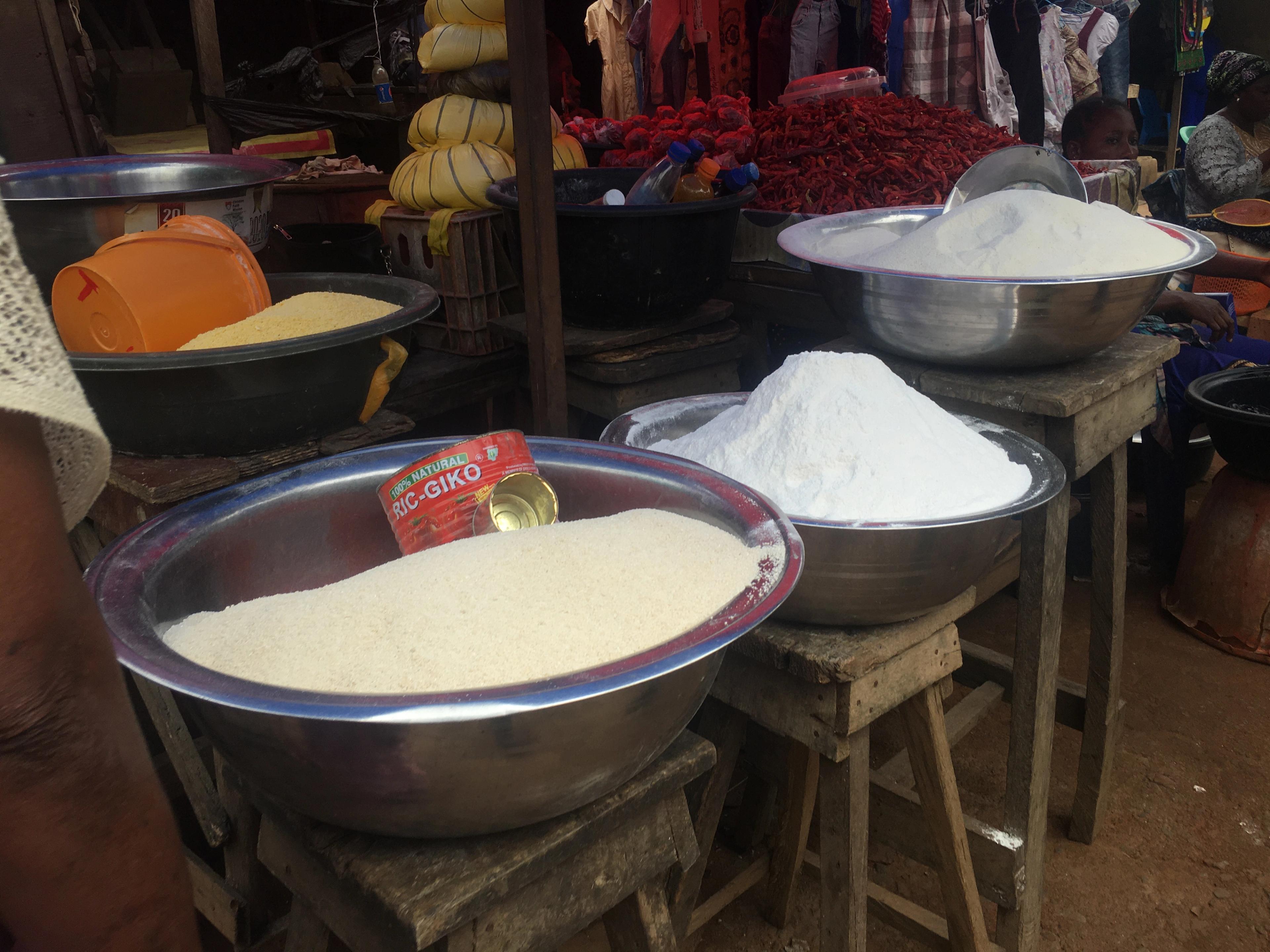 Bowls of grain and milled cereals on display at a local market.