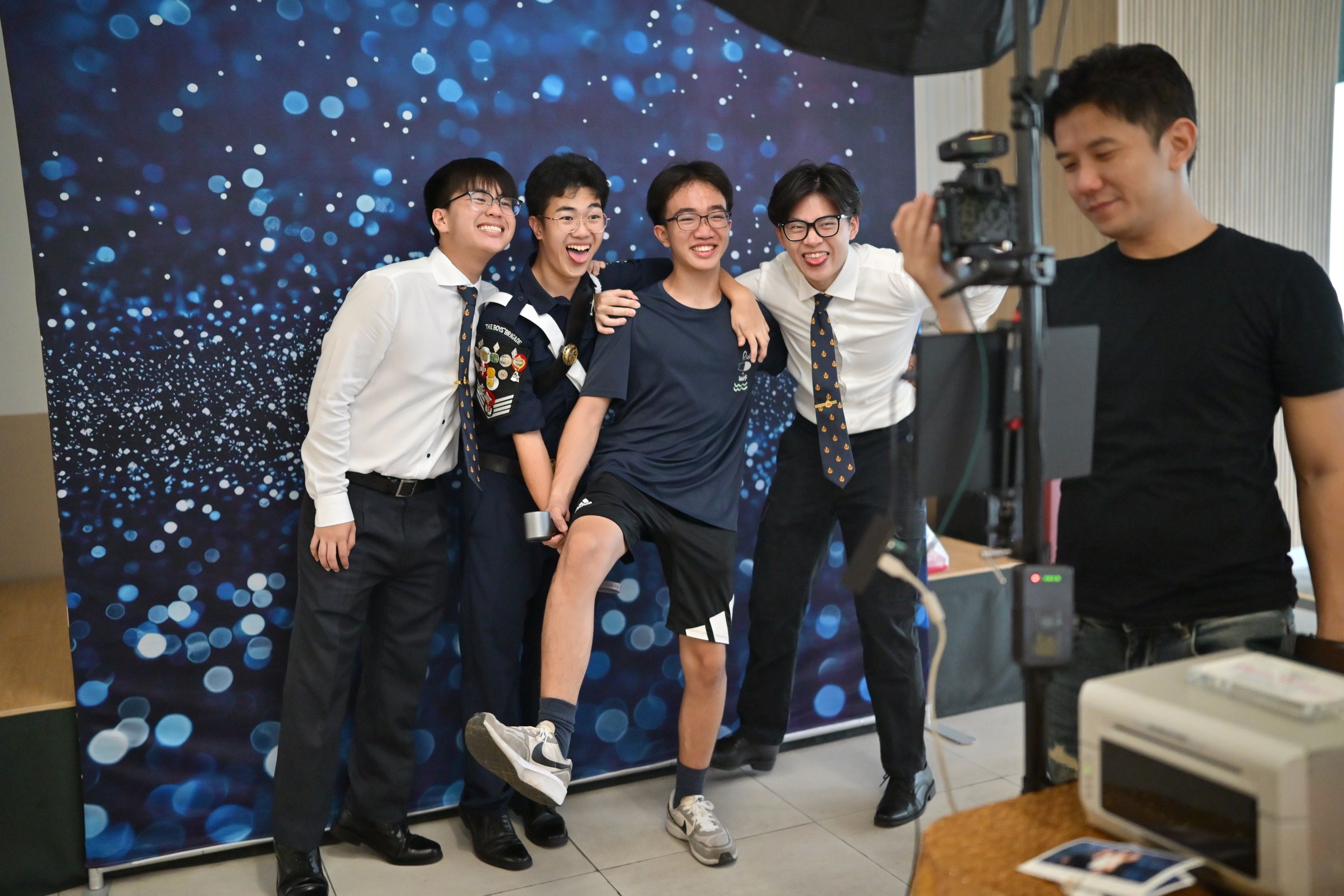 Youths and BB volunteers posing at a photobooth