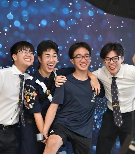 Youths and BB volunteers posing at a photobooth