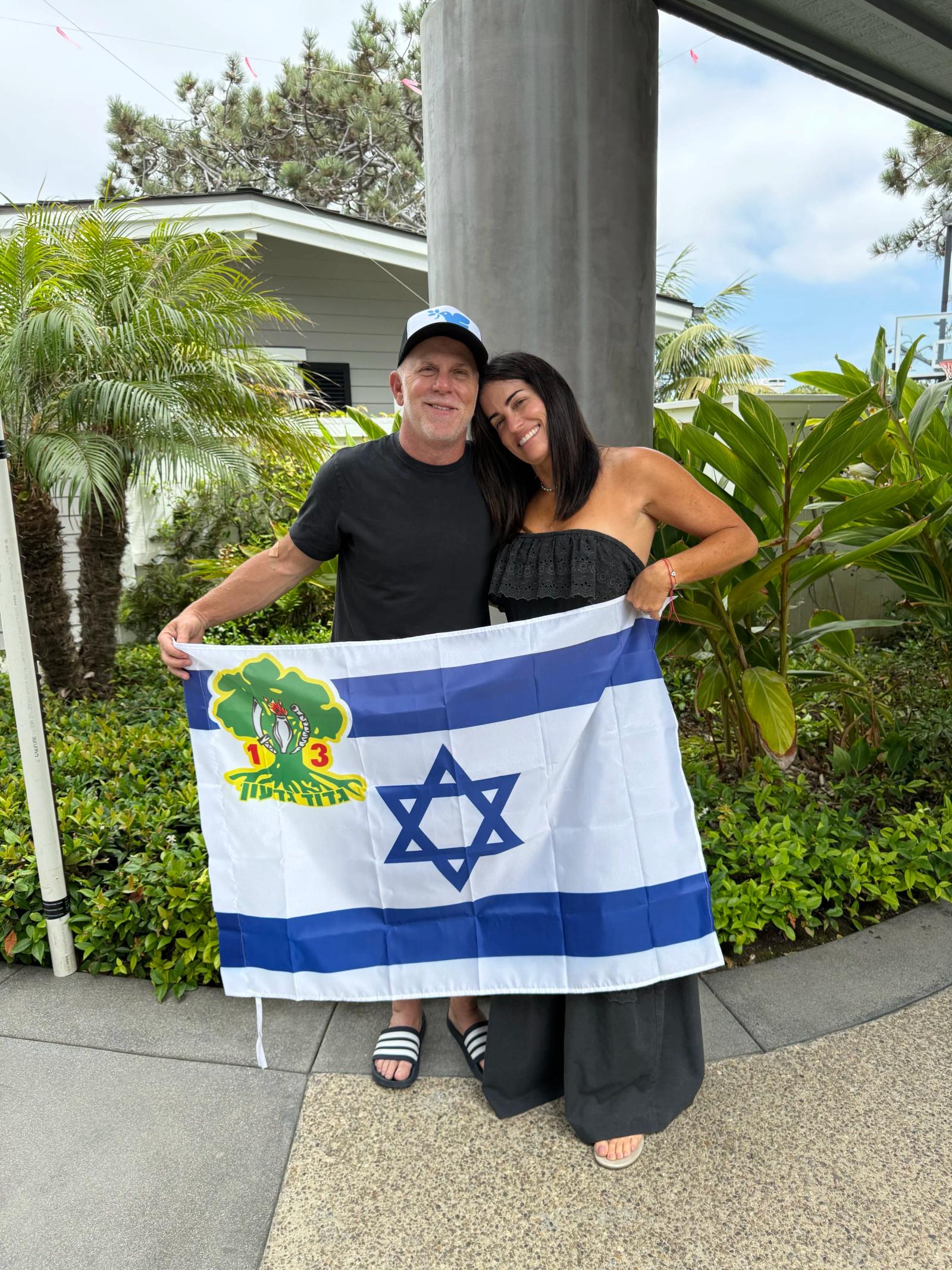 Jewmanity founders holding a flag for Isreal