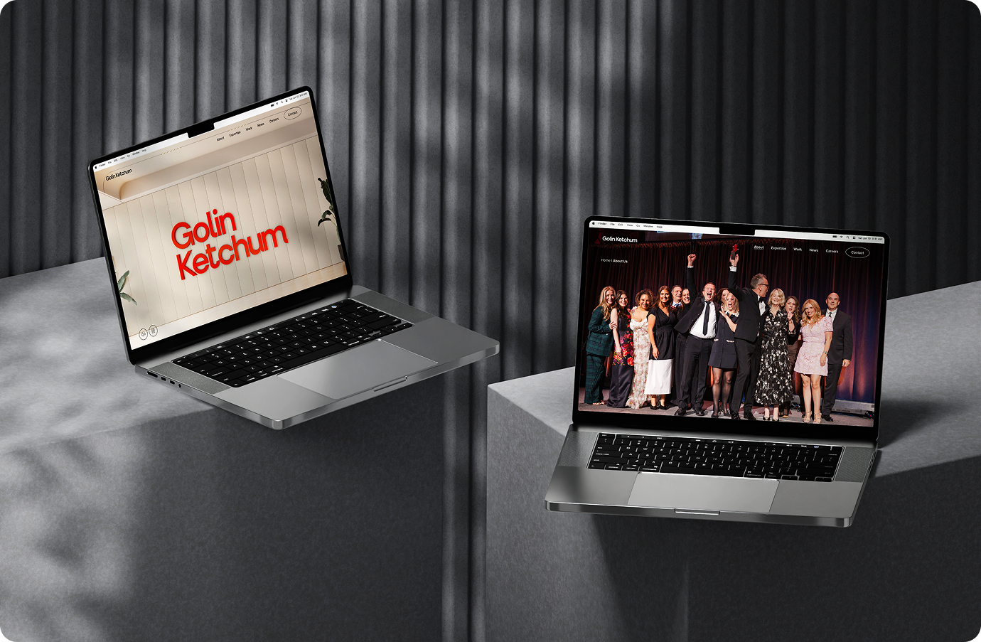 Two laptop screens showing featured banners from Golin Ketchum website