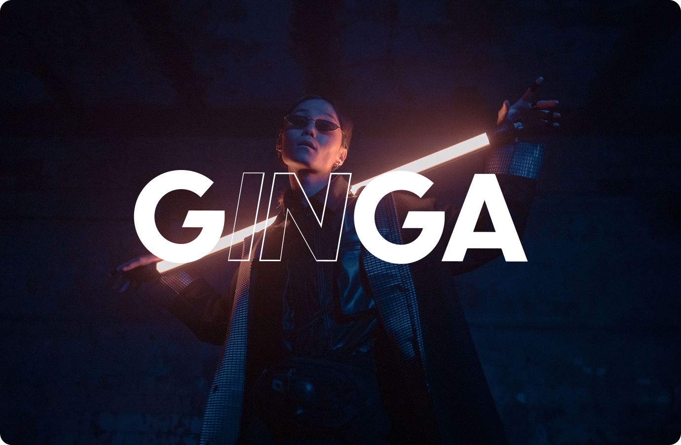 Stylish model holding a bright lamp and the word GINGA in the foreground