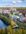 Flygbild visar bebyggelse längs med Husarviken möter Nationalstadsparken