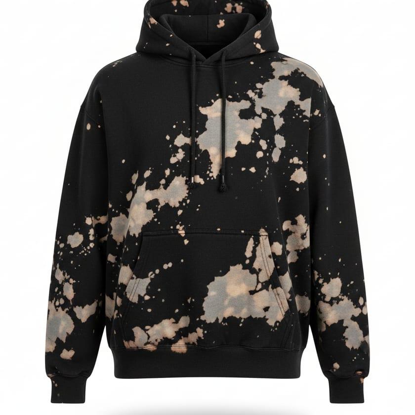 Black hoodie with a bleach-splatter wash finish