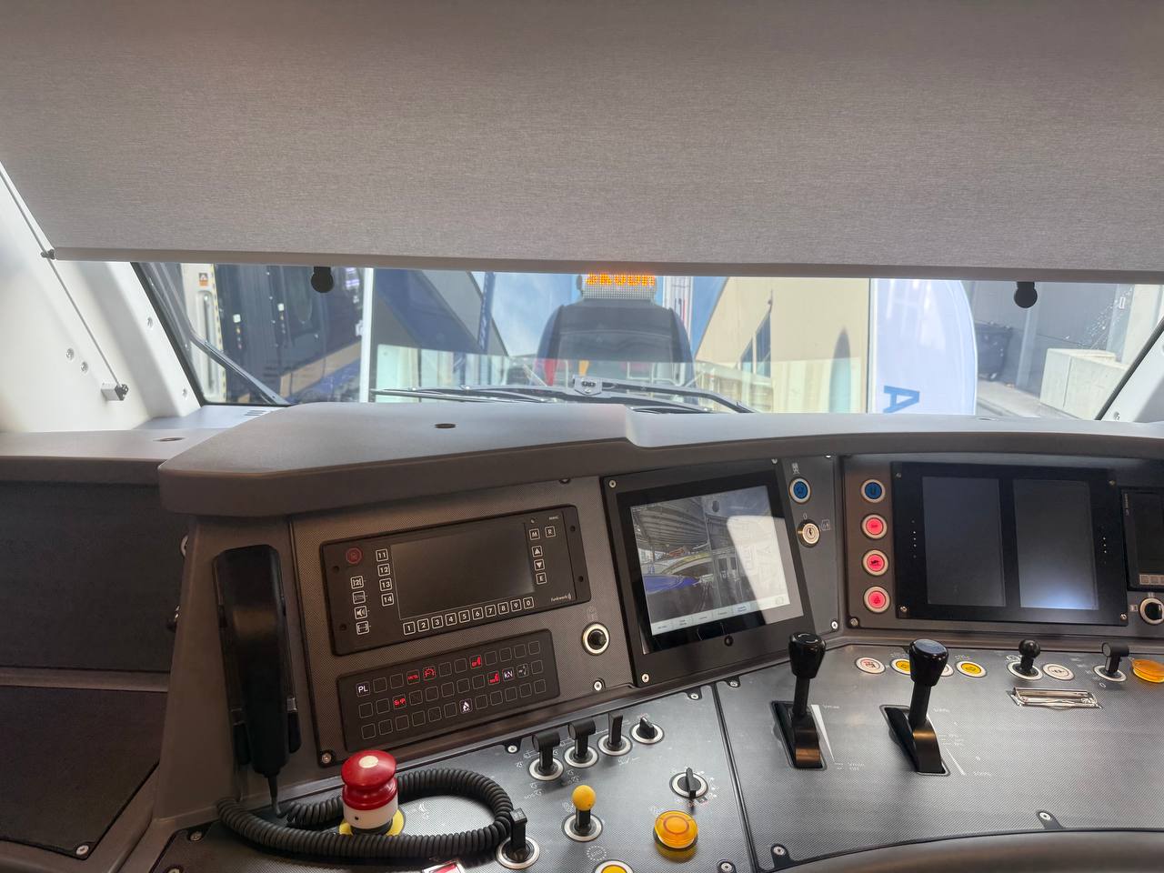 A modern driver’s cab on display, combining digital displays with on-board control systems.