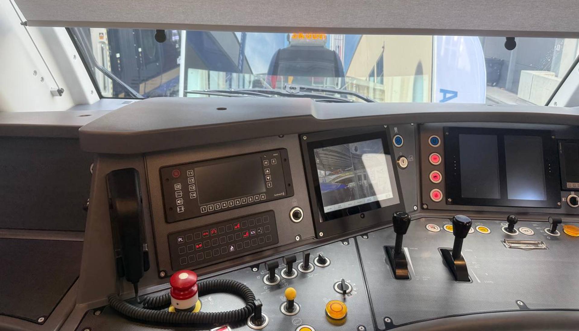 A modern driver’s cab on display, combining digital displays with on-board control systems.