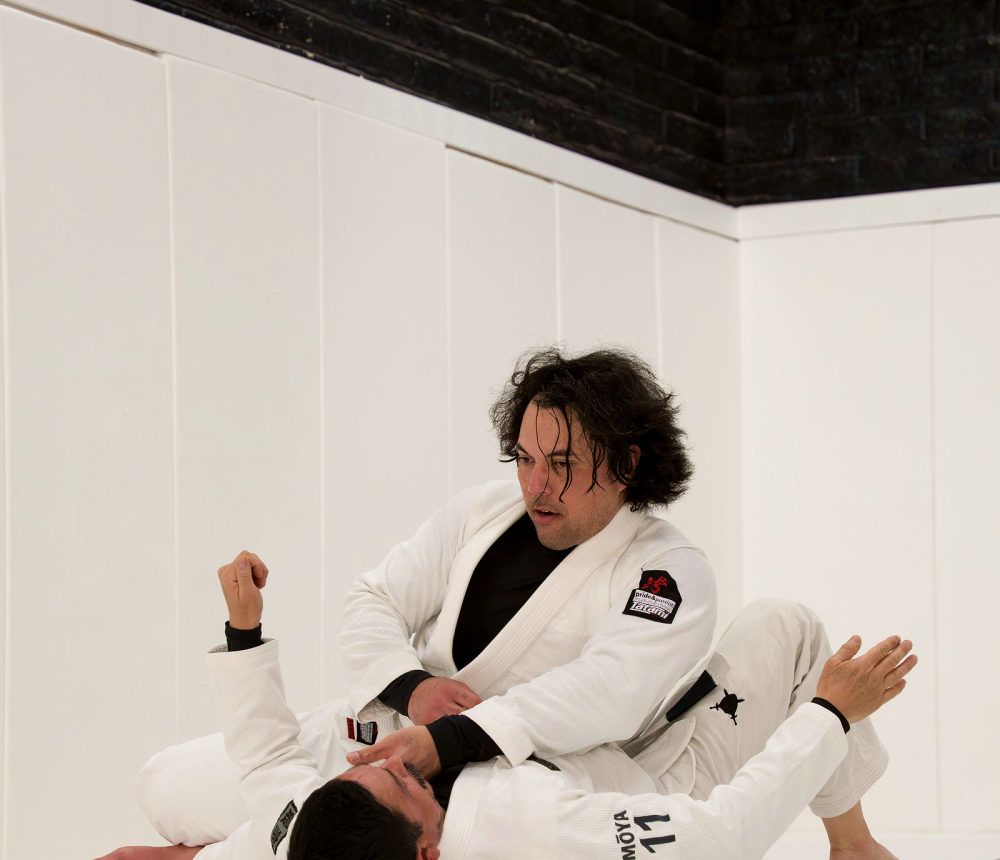 Two students rolling in the gi at Pace