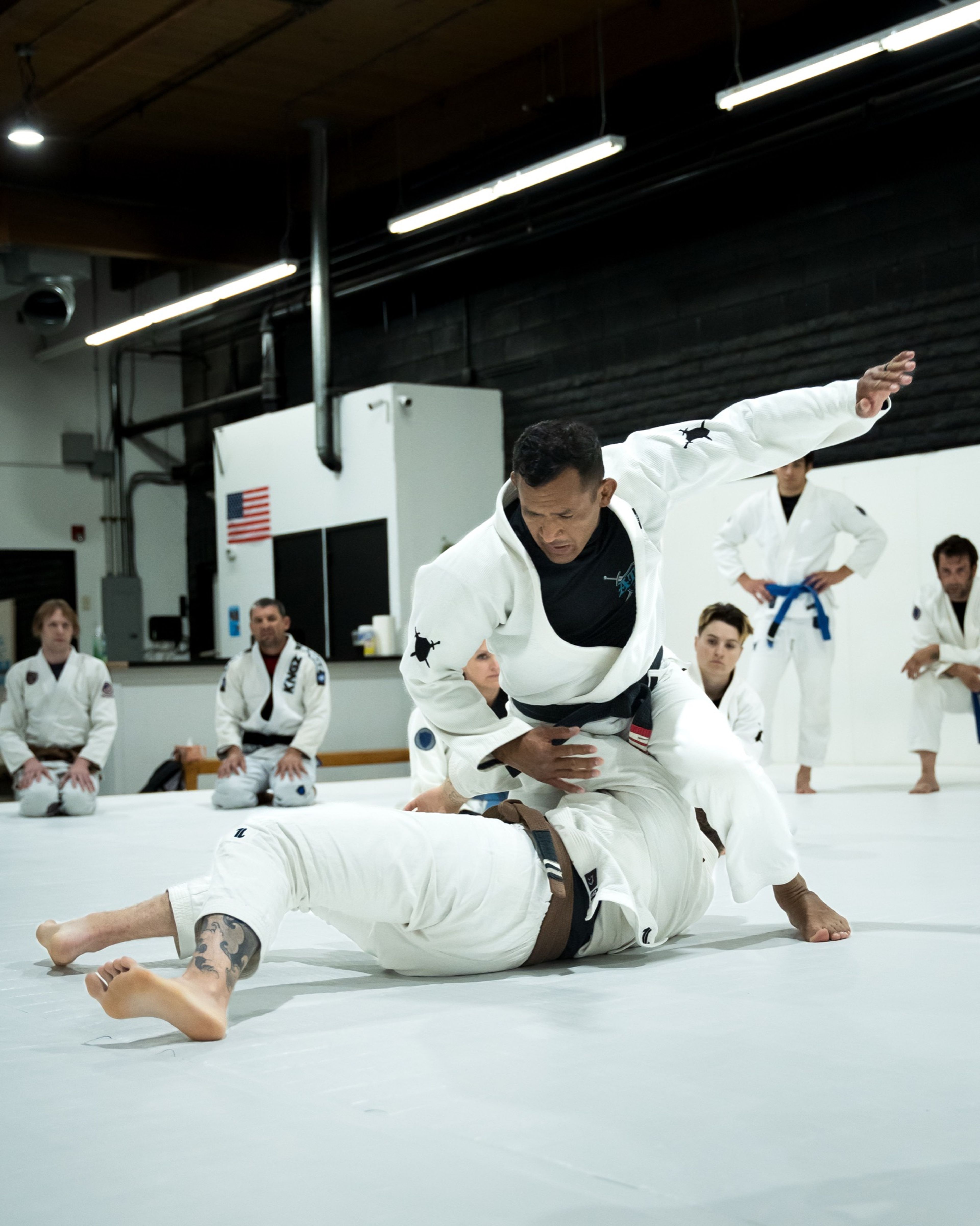 A coach demonstrating a pass from top position