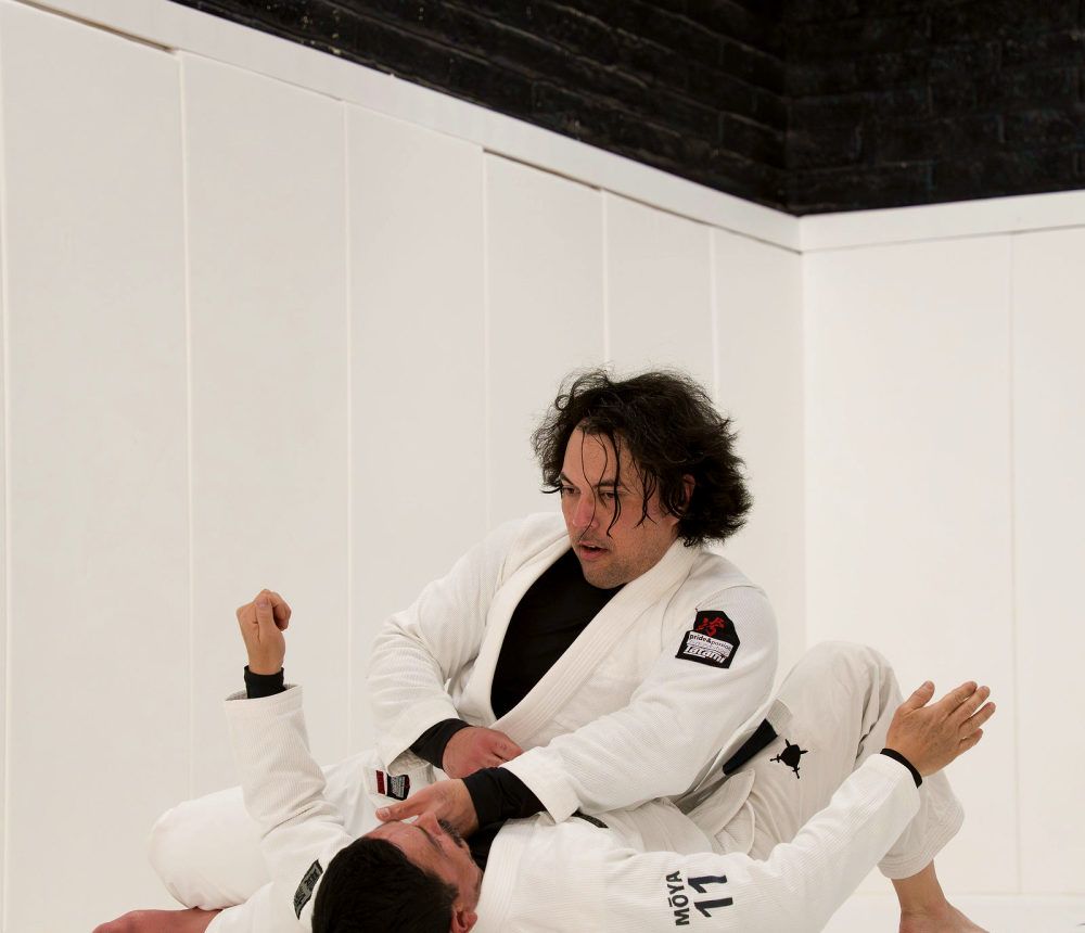 Two students rolling during class at Pace