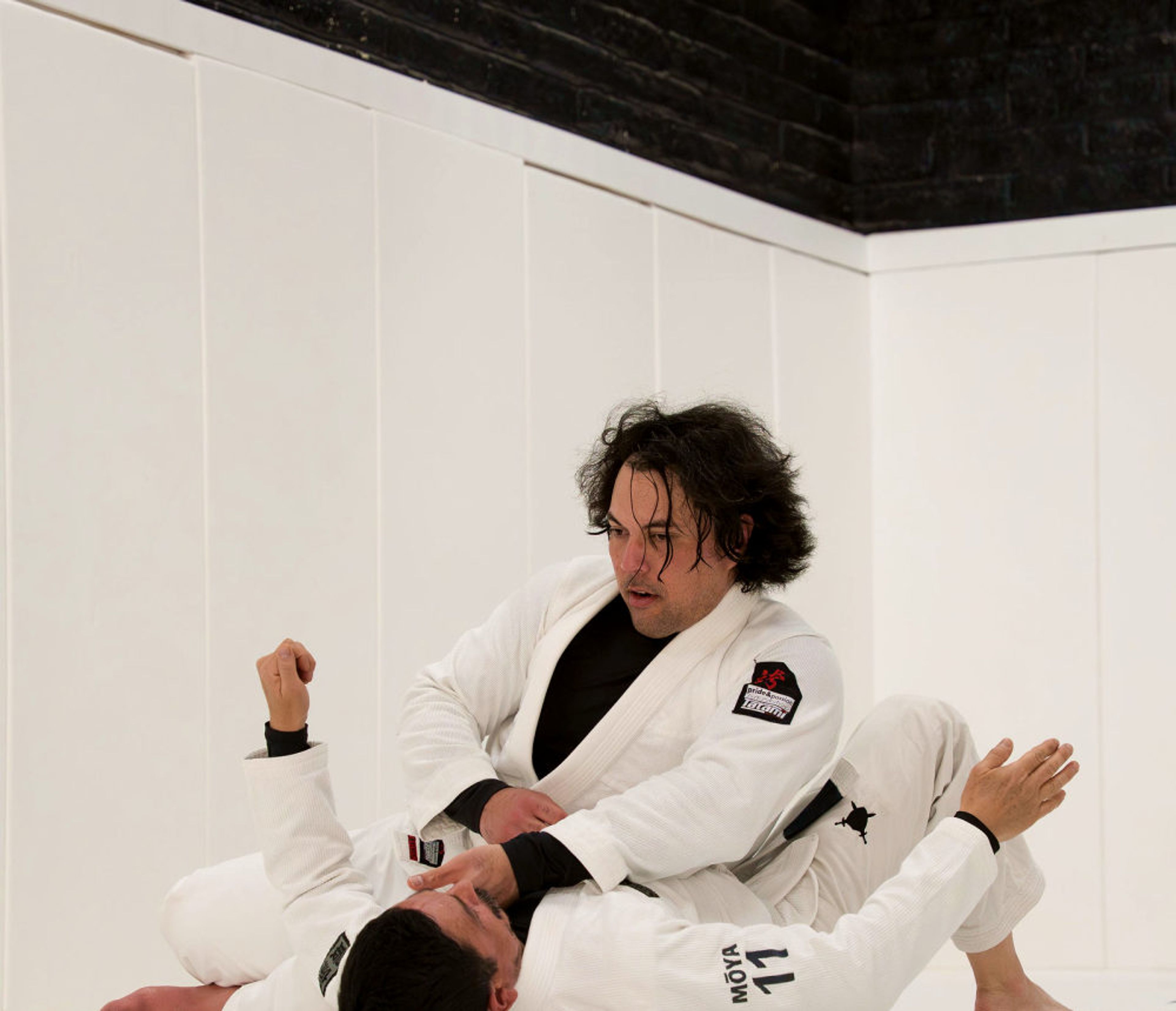 Two students rolling during class at Pace