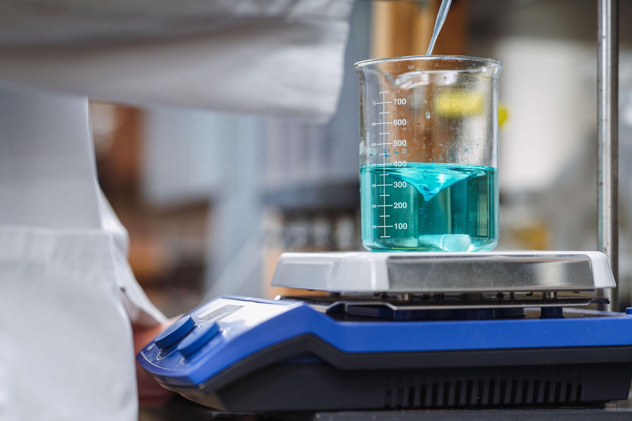 Chemistry beaker with blue-green liquid