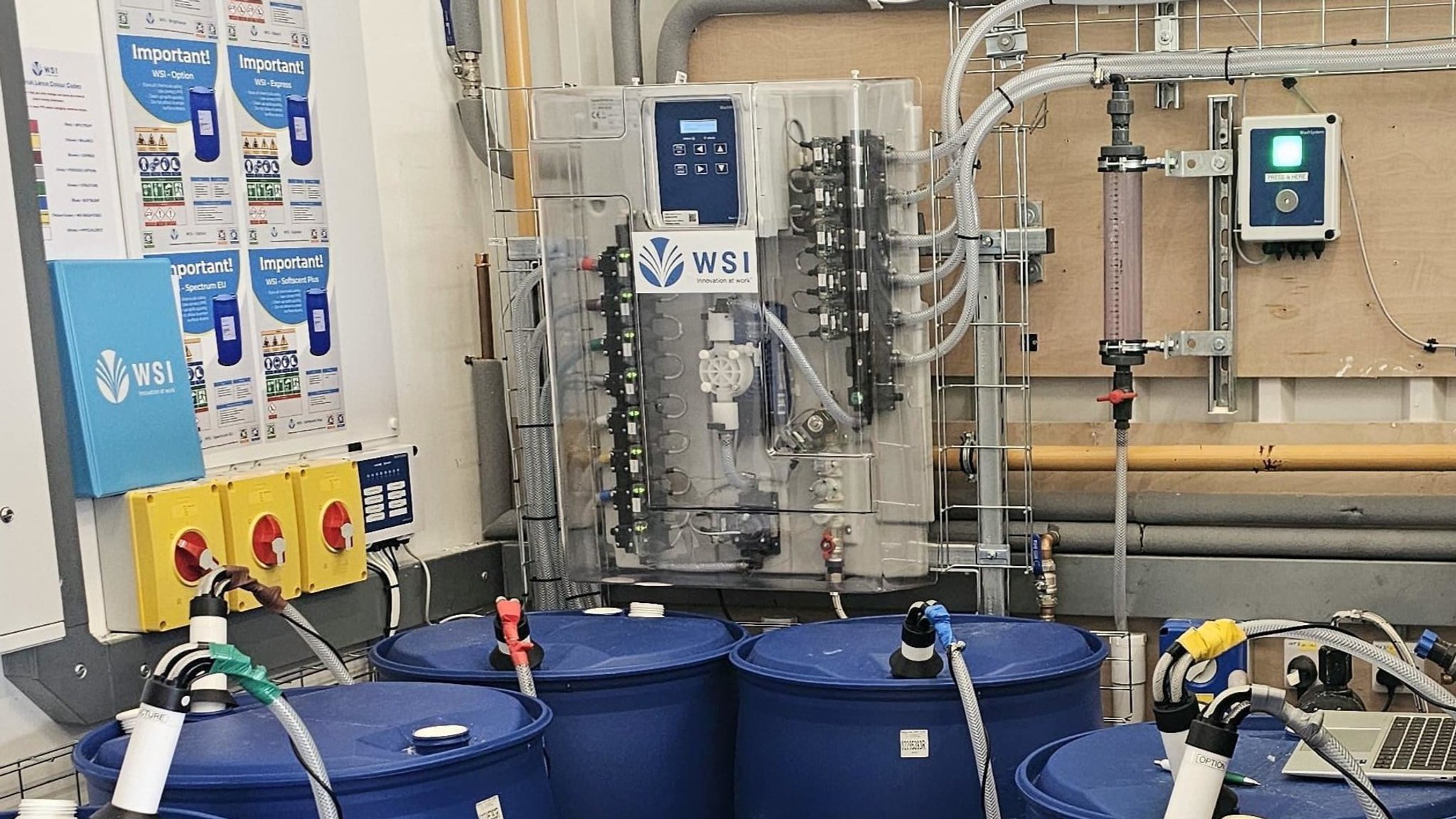 WSI dosing and monitoring system installed above the chemical drums at Guest Linen