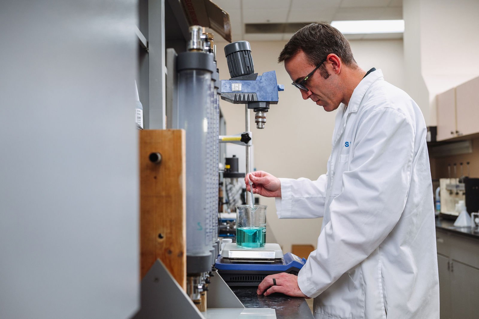 Lab technician testing water treatment chemical solution
